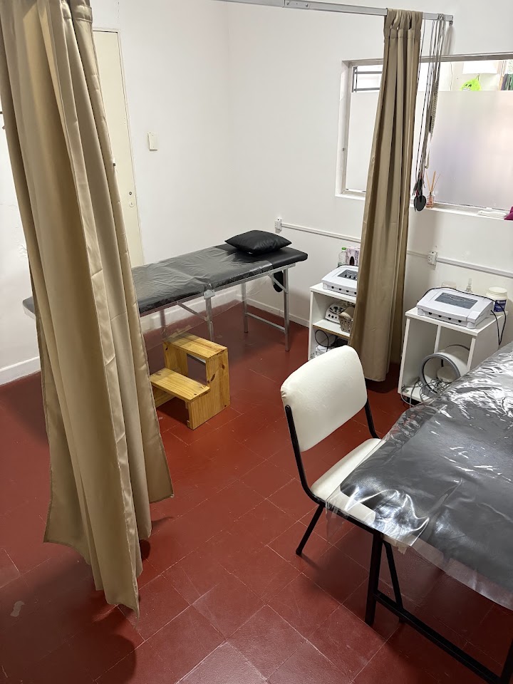 Sala de tratamiento del consultorio, con camilla y equipamiento de kinesiología